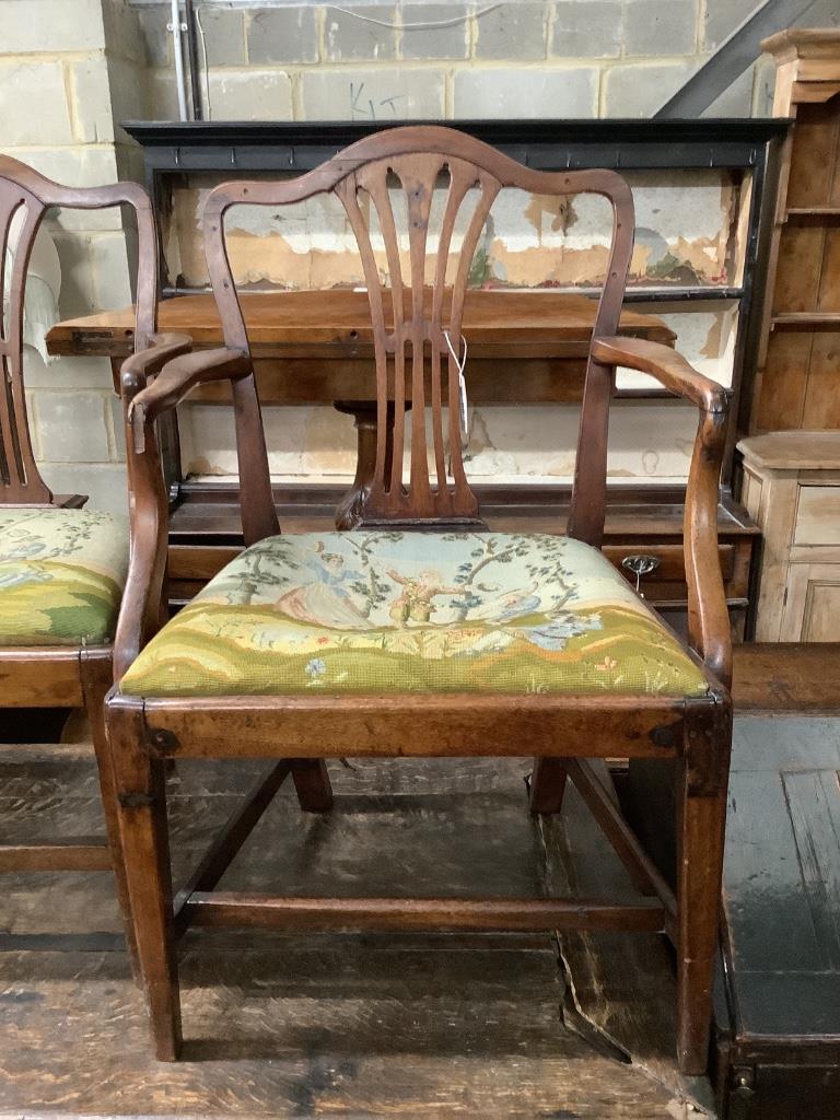 A pair of George III mahogany open elbow chairs